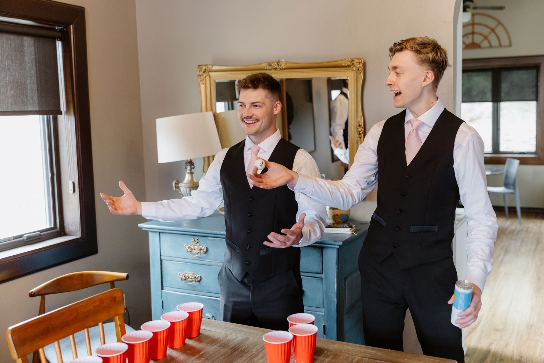 Groomsmen laughing together while getting ready at The Geologist House