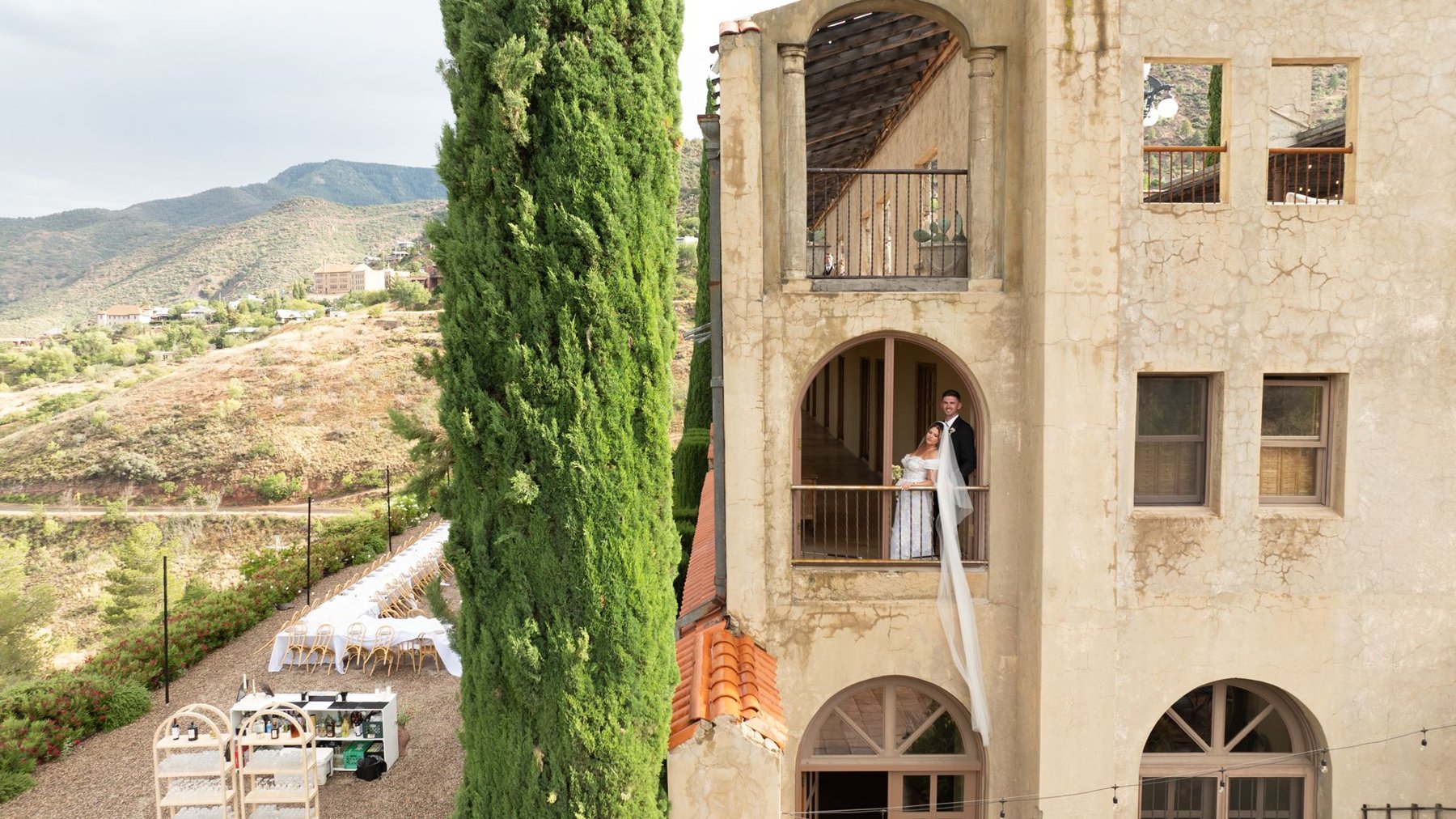 Aerial view of Abigail and Ethan on the balcony beside the reception area