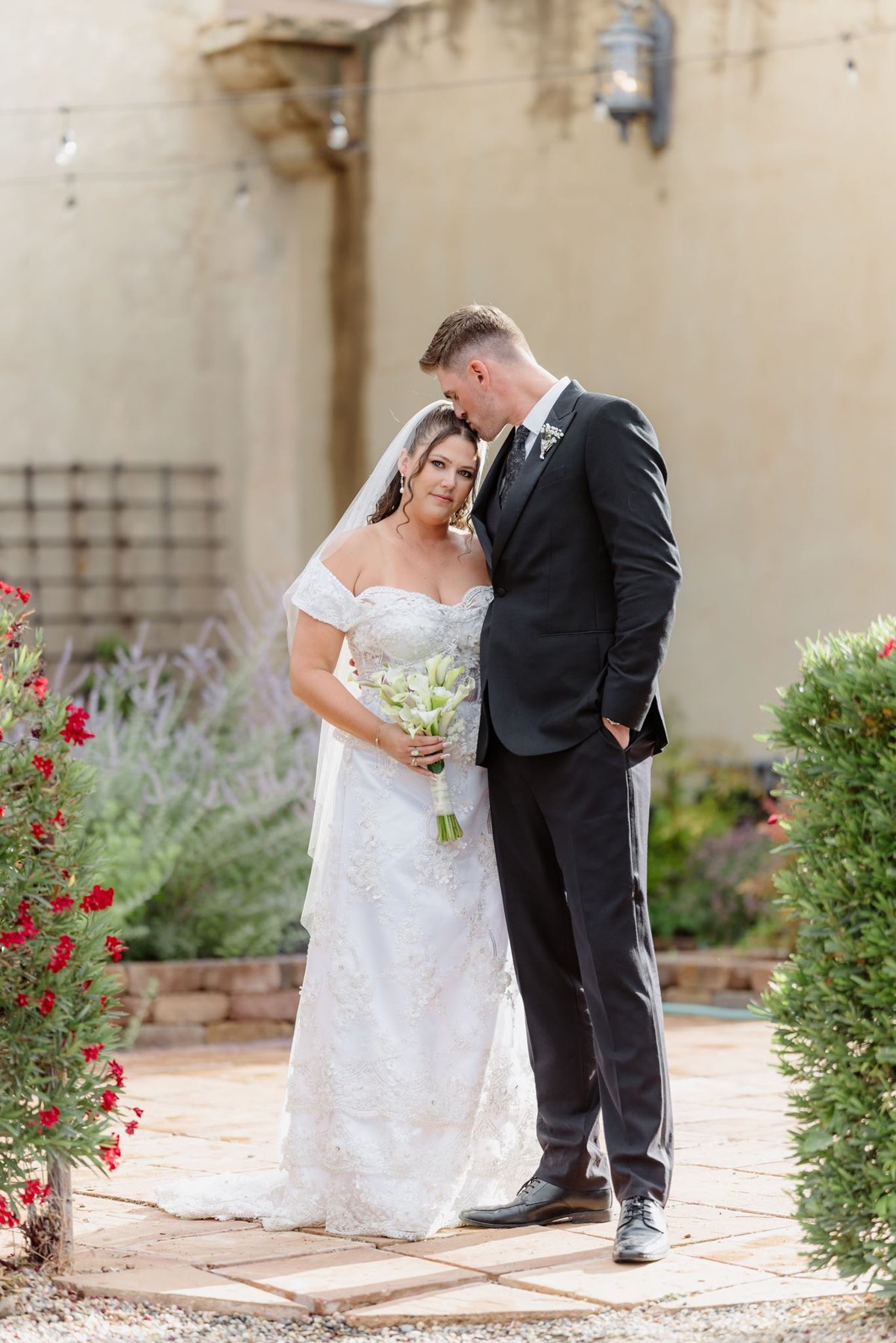 Ethan kissing Abigail’s forehead during their newlywed portraits