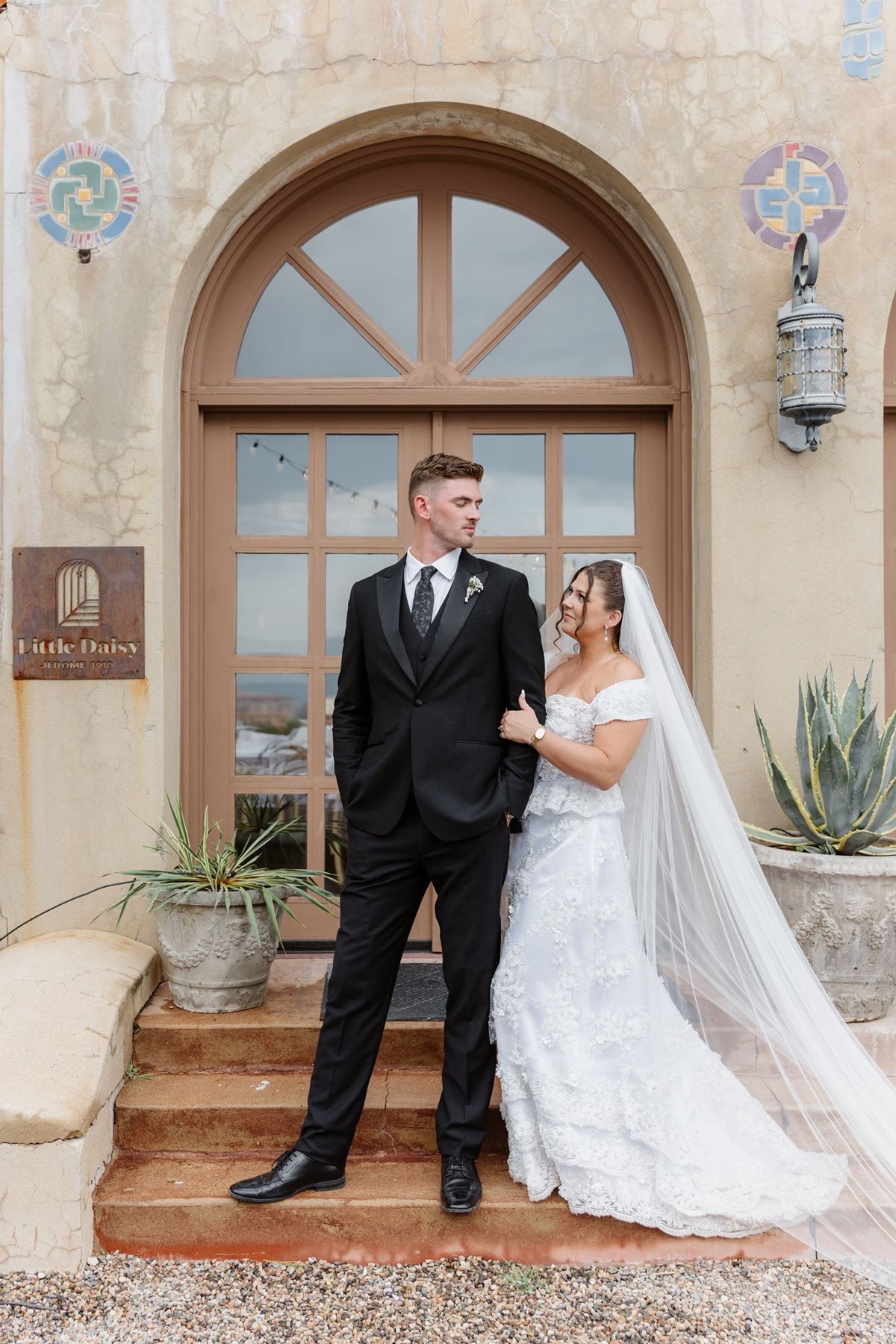 Abigail and Ethan posing at the estate’s arched entrance