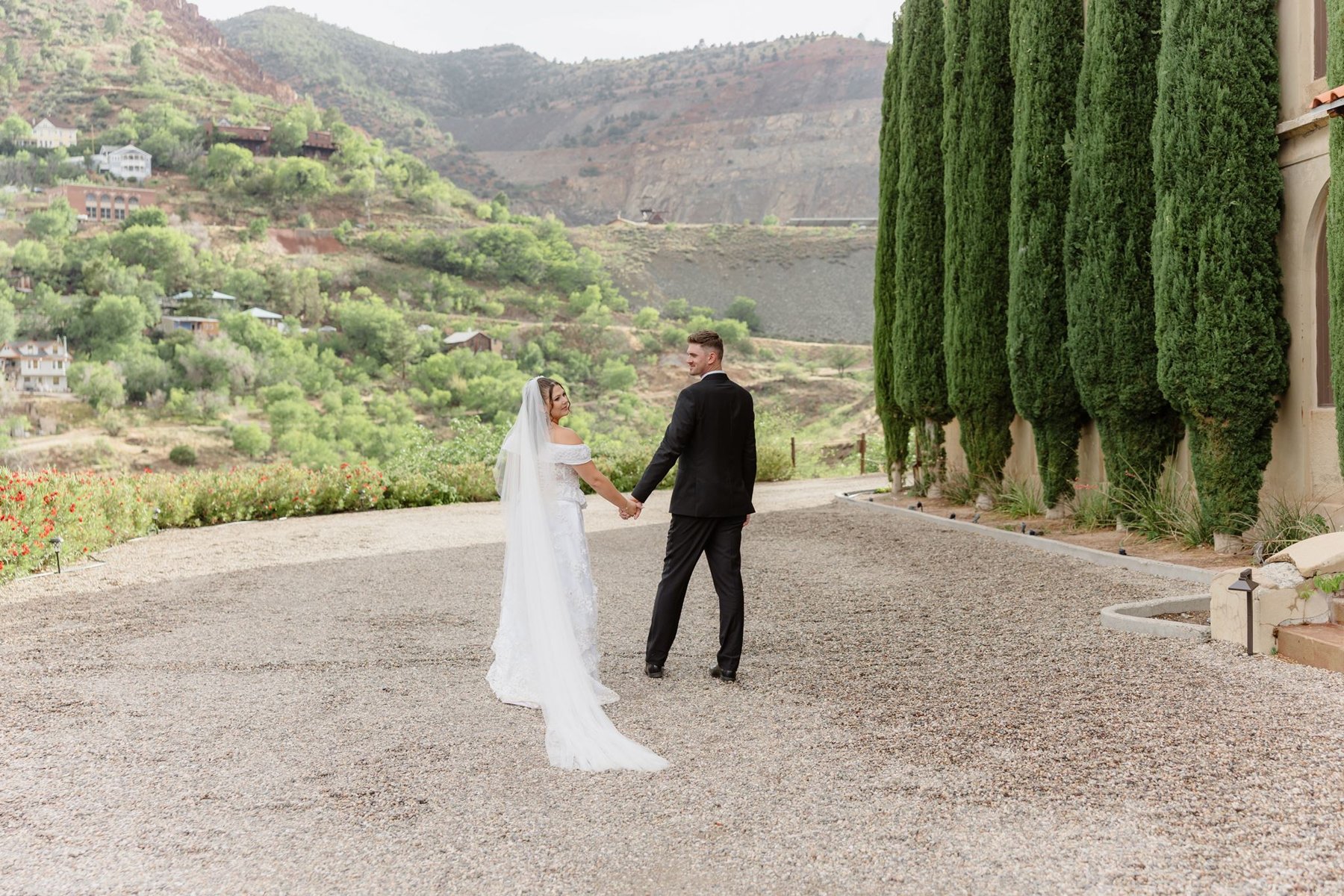 Abigail and Ethan holding hands with the Verde Valley landscape behind them