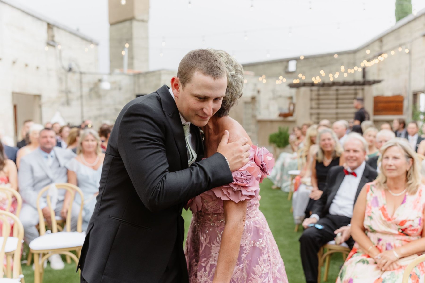 Ethan kissing his mother’s hand during the wedding processional