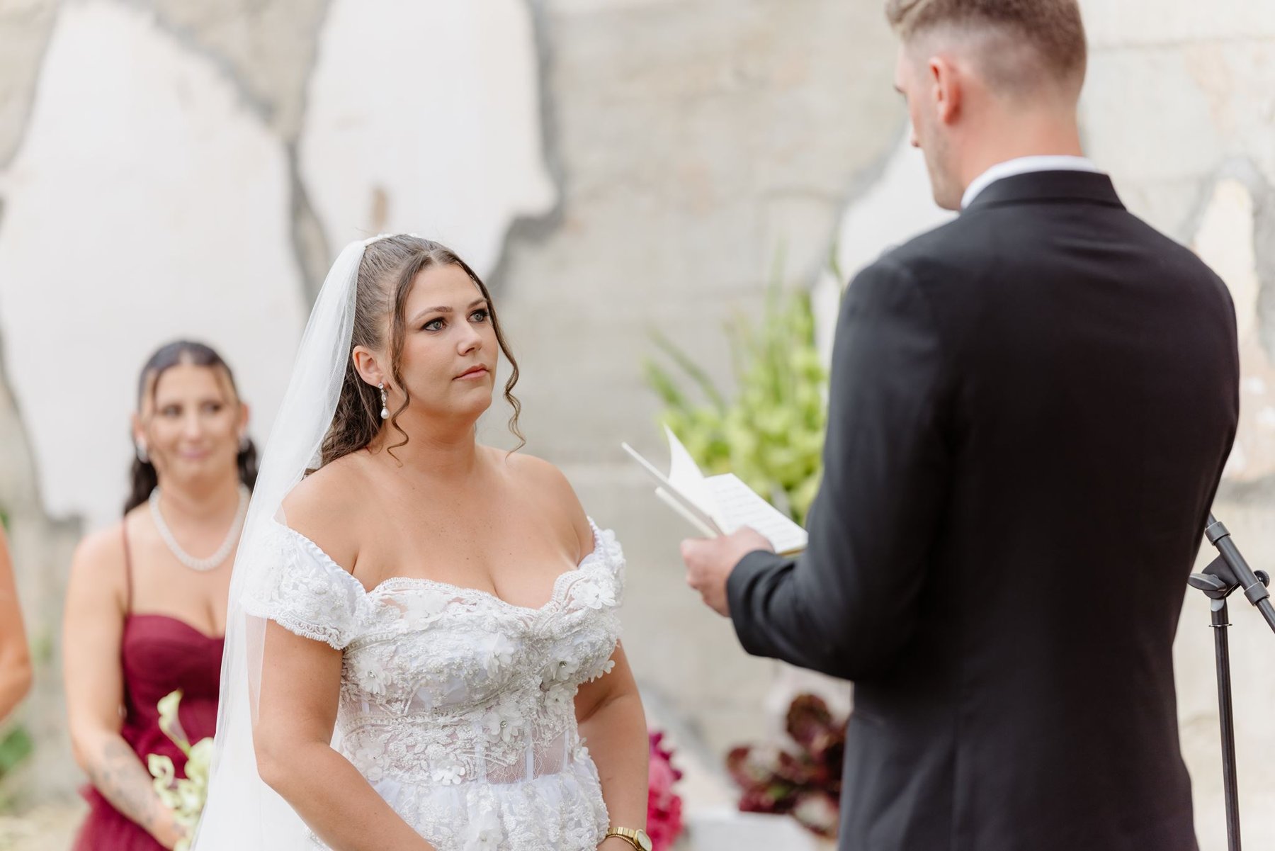 Abigail listening as Ethan reads his wedding vows
