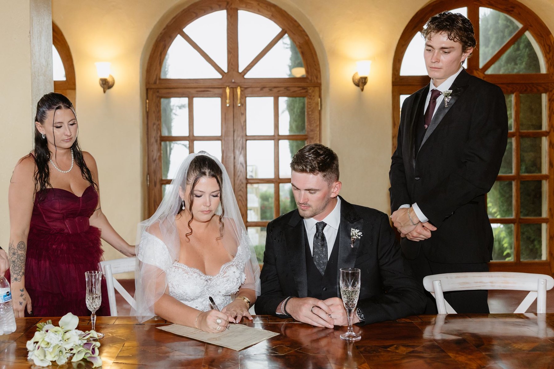 Abigail and Ethan signing their marriage license with witnesses