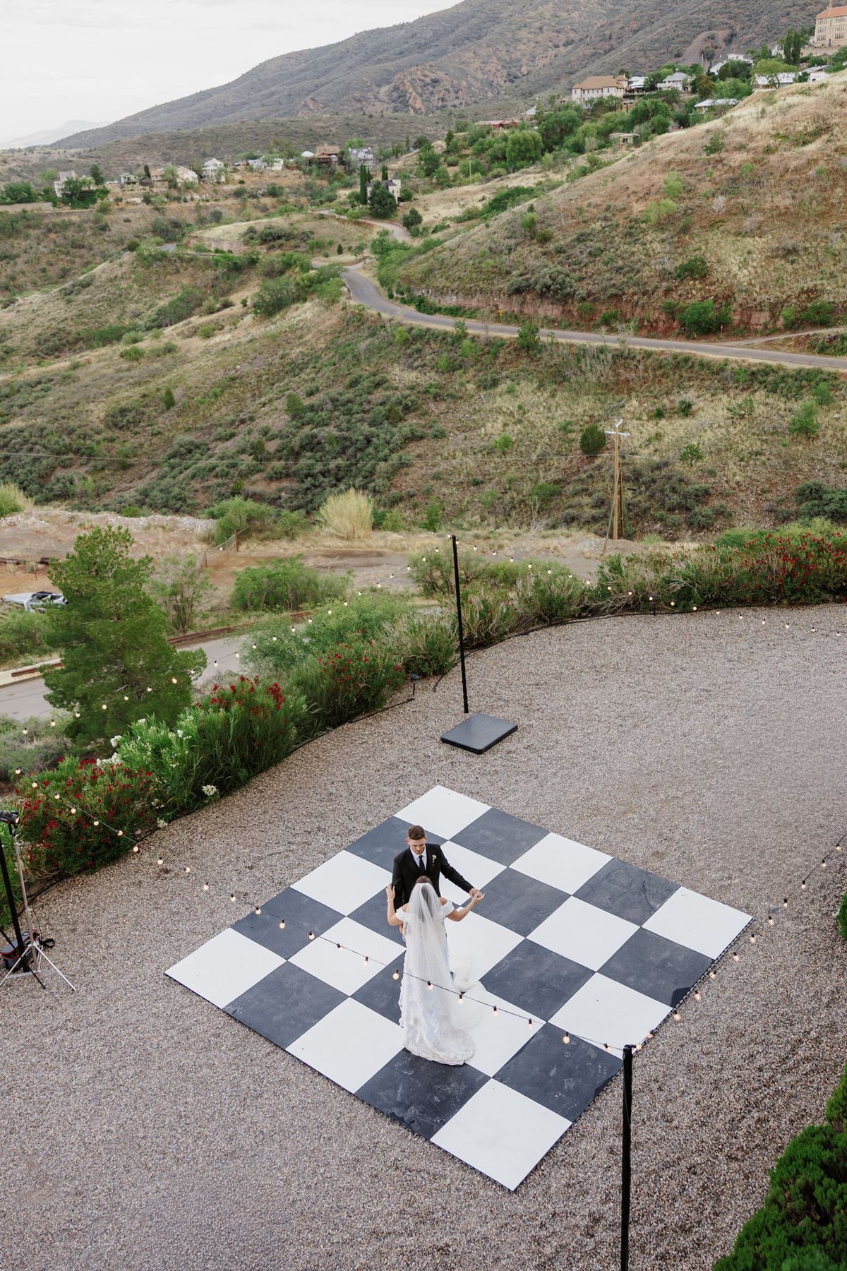 Aerial view of Abigail and Ethan’s first dance on the checkered dance floor