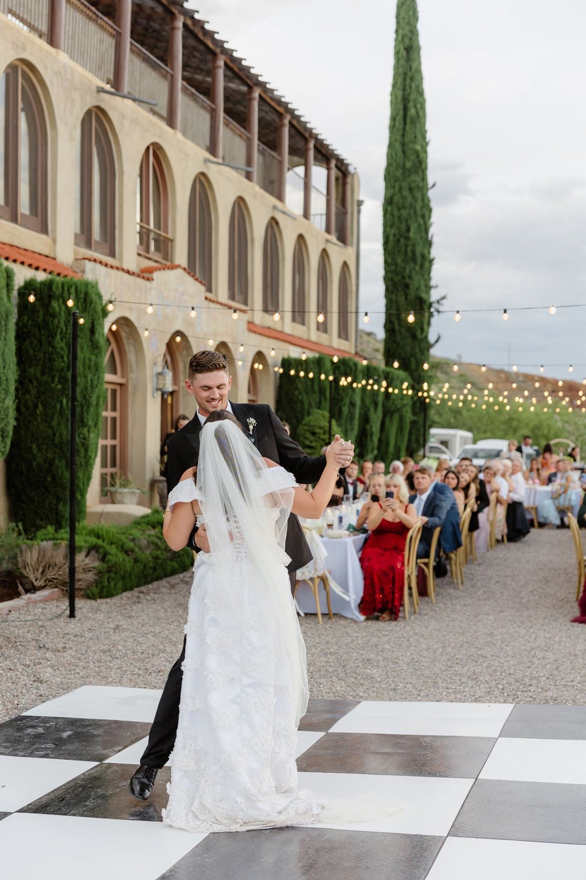 First dance with The Little Daisy estate and wedding guests in the background