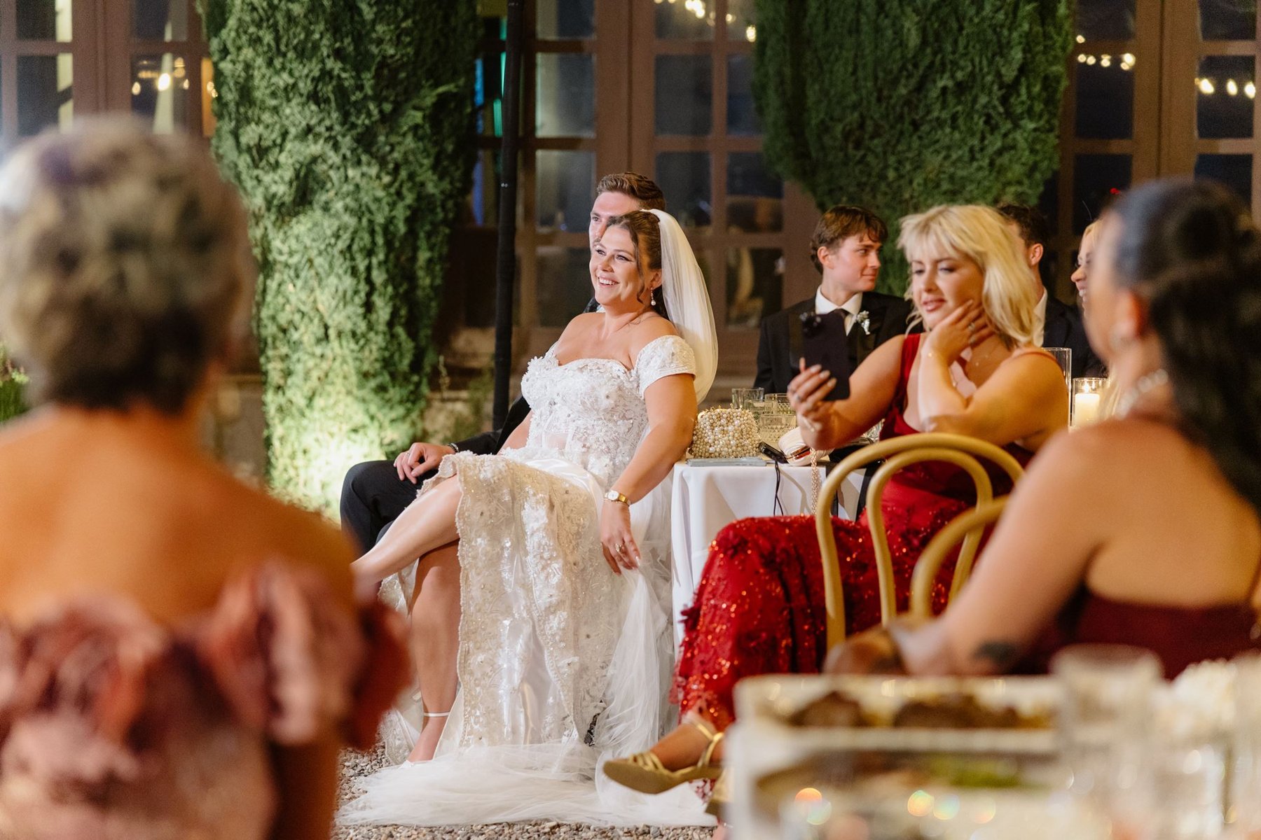Abigail laughing with guests during the outdoor wedding reception