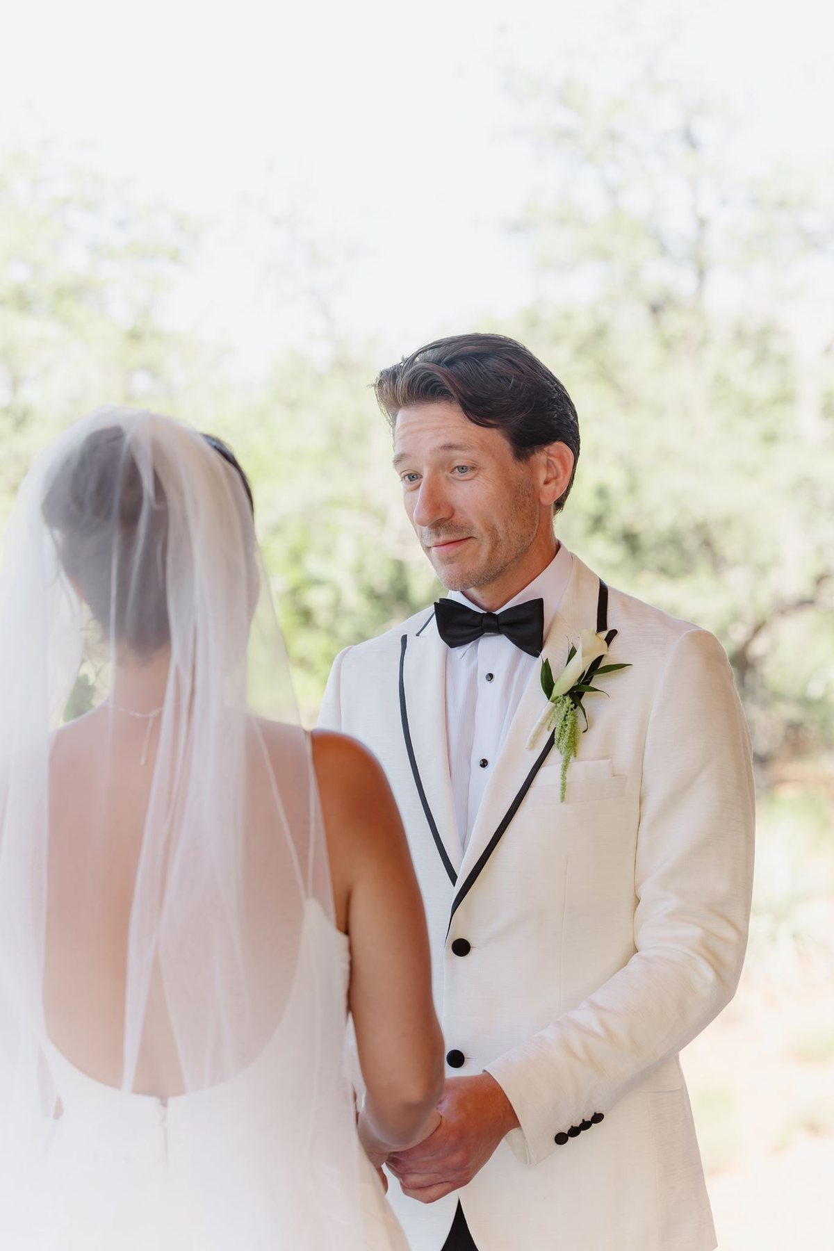 Maggie and Brandon holding hands during their intimate Sedona wedding ceremony