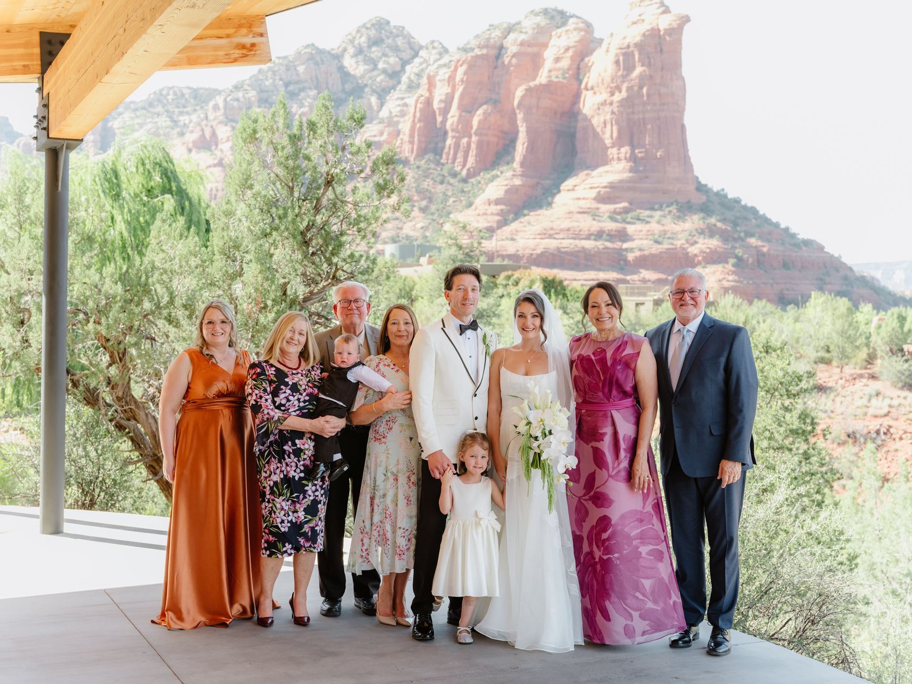 Maggie and Brandon with their family beneath the covered terrace and Sedona red rock views