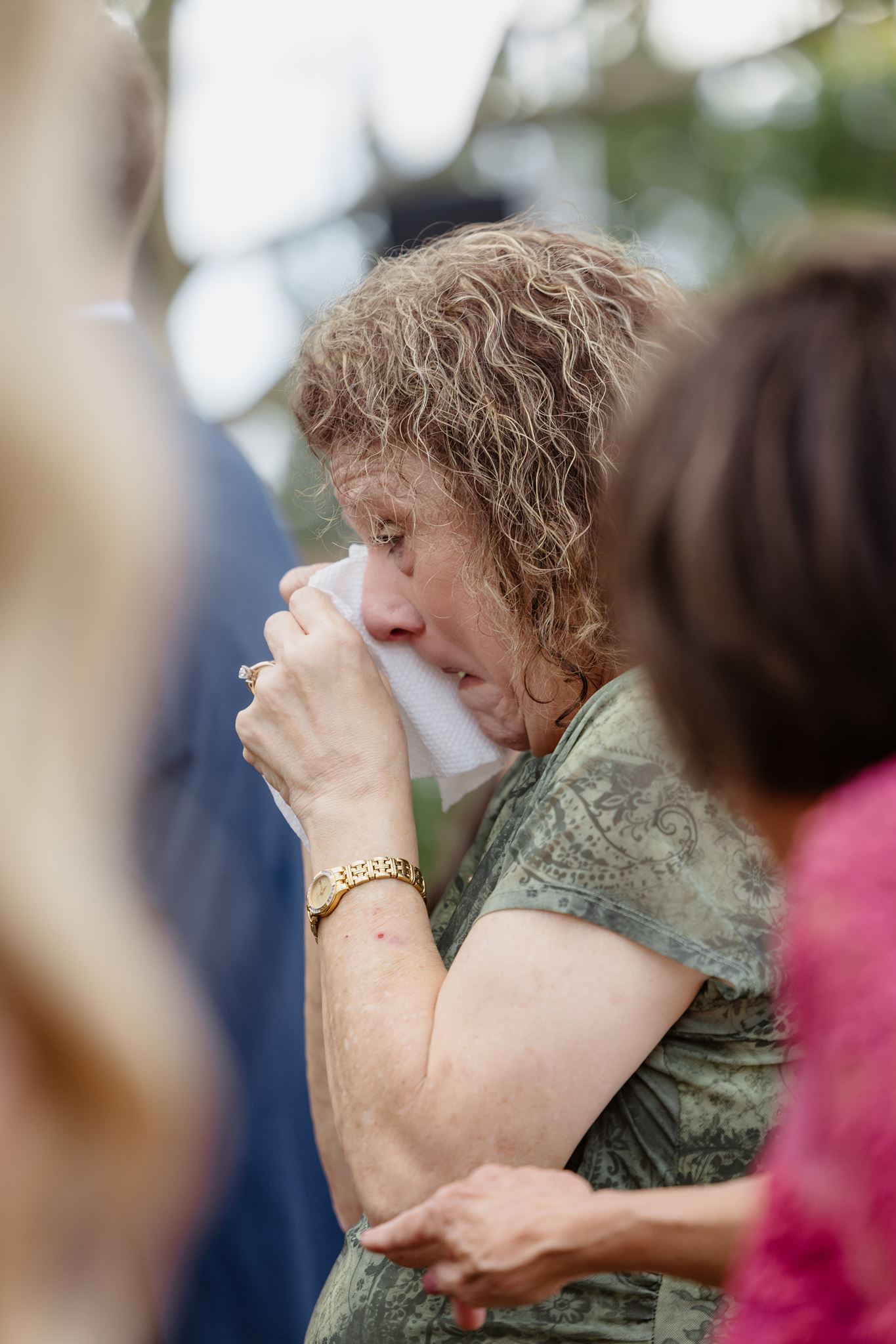 A wedding guest wiping away tears during Kylie and Peyton’s ceremony.