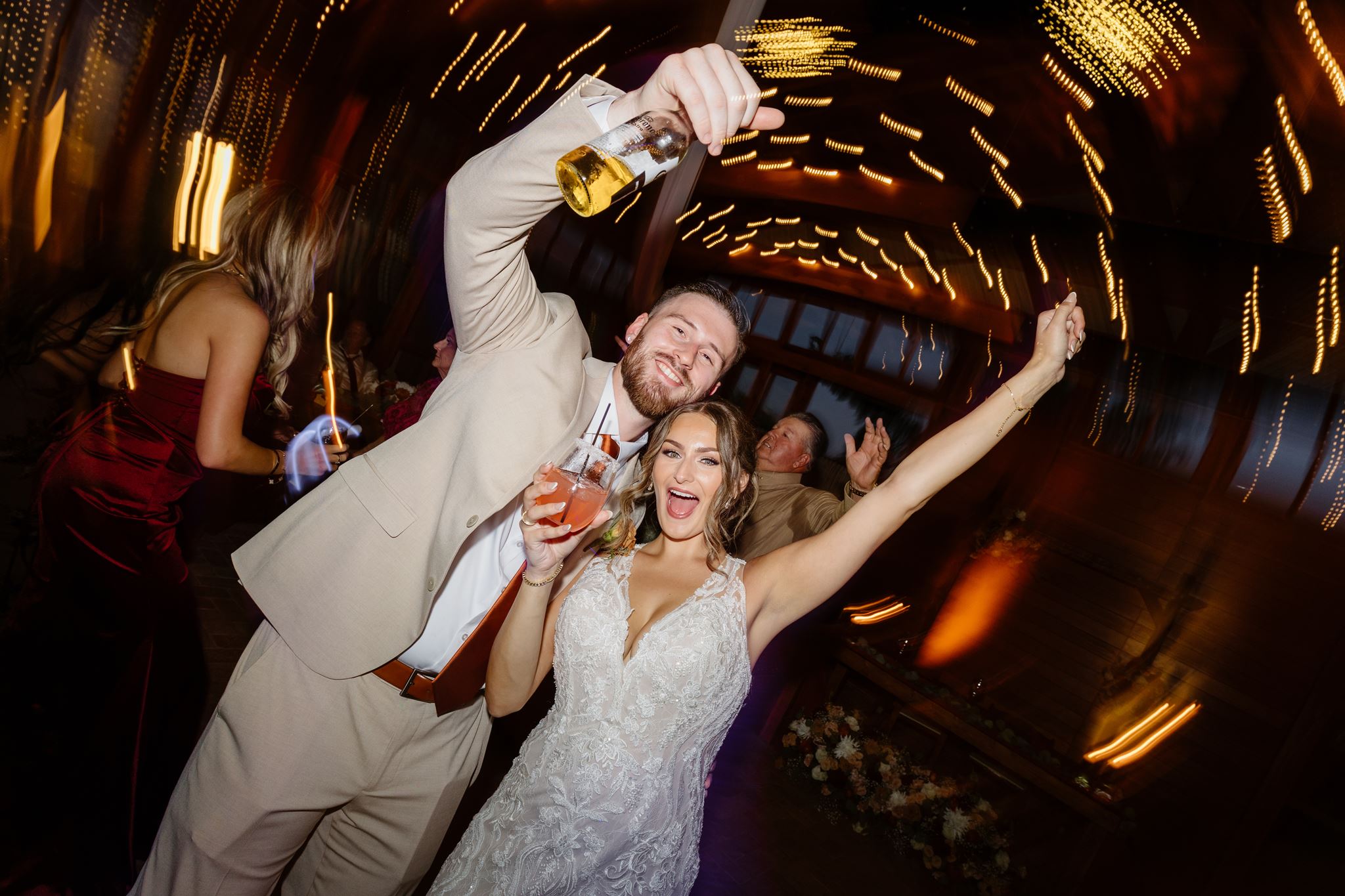 Kylie and Peyton celebrating on the dance floor beneath swirling string lights.